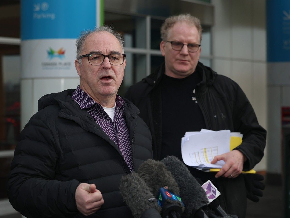  Neil Wyles, foreground, executive director of the Mount Pleasant Business Improvement Area, talks to the media on Jan. 27 in Vancouver as SkyTrain construction is taking longer than expected.