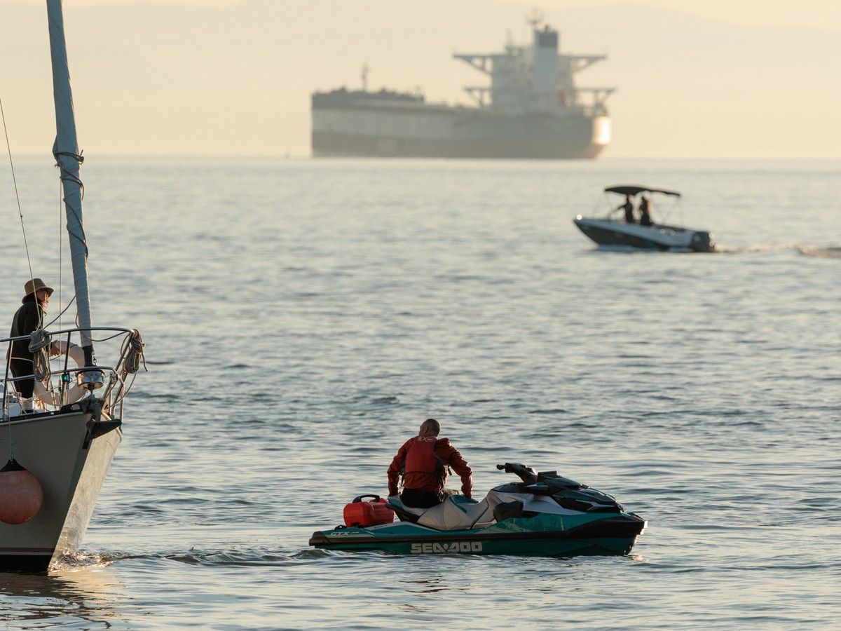 An individual riding a Sea-Doo who struck a grey whale near Stanley Park in Vancouver, B.C. on the evening of Monday, May 4, 2026 can be seen in the water climbing back onto his watercraft following the collision.