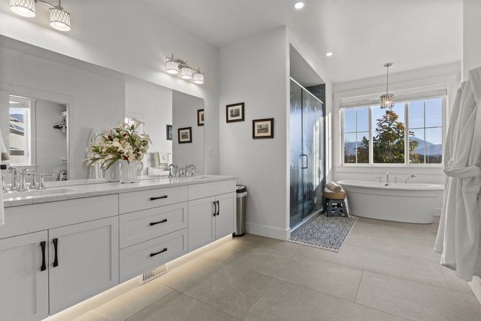  The two primary bedroom en suites feature a soaker tub.