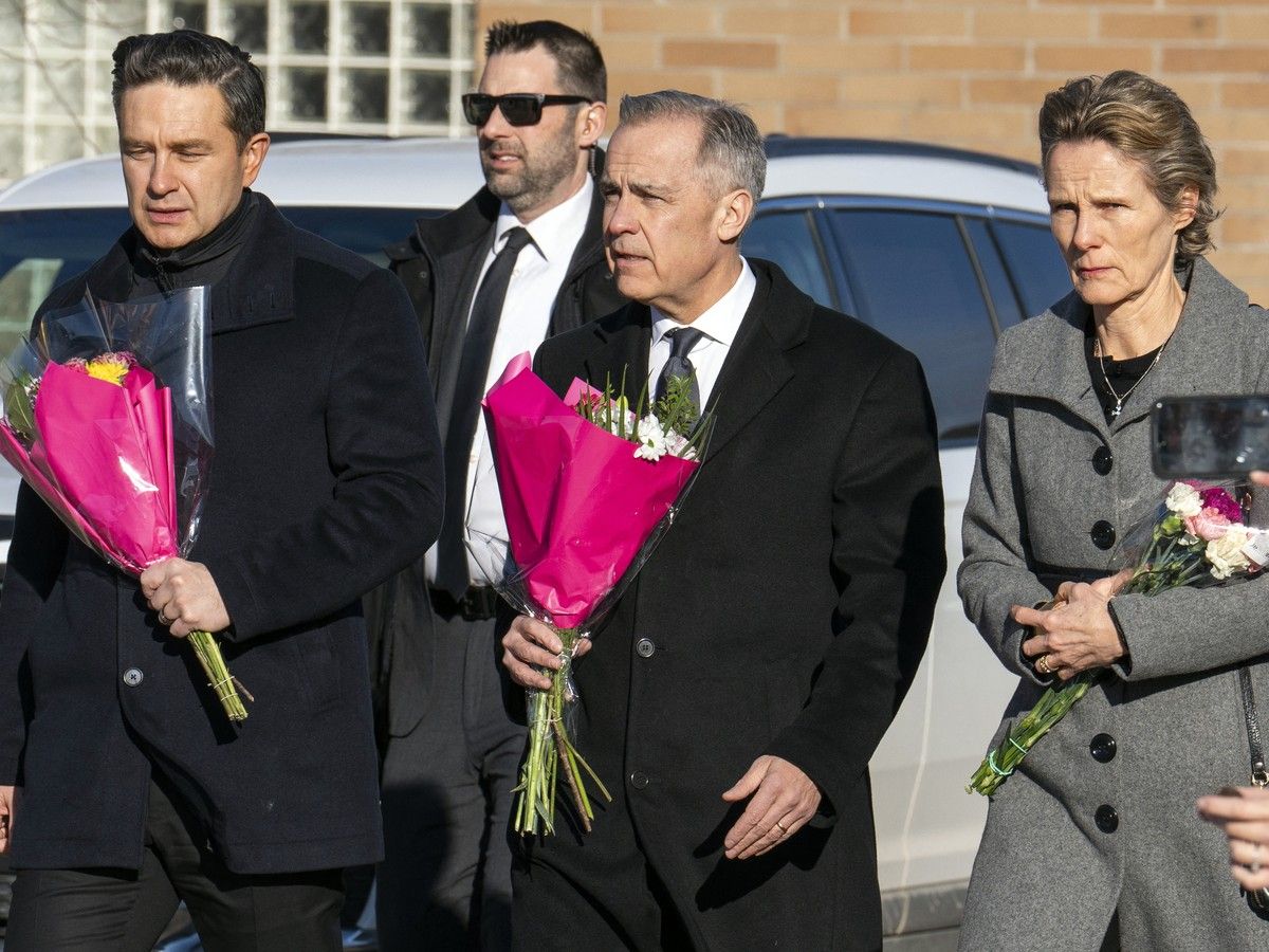  From left, Pierre Poilievre, the leader of the Conservative Party of Canada, Canadian Prime Minister Mark Carney, and Diana Fox Carney carry flowers are they arrive at a makeshift memorial for the victims of the mass shooting in Tumbler Ridge in February.