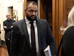 Forests Minister Ravi Parmar leaves the chamber at the legislature.
