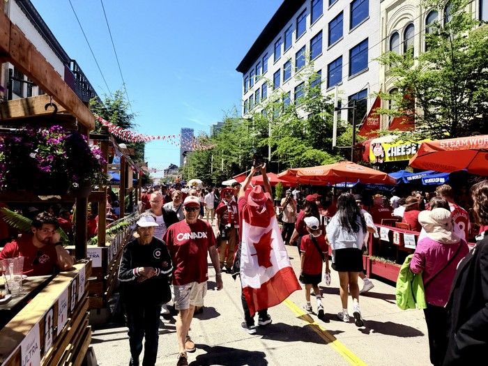  people walk along granville street during the world cup. brent toderian photo