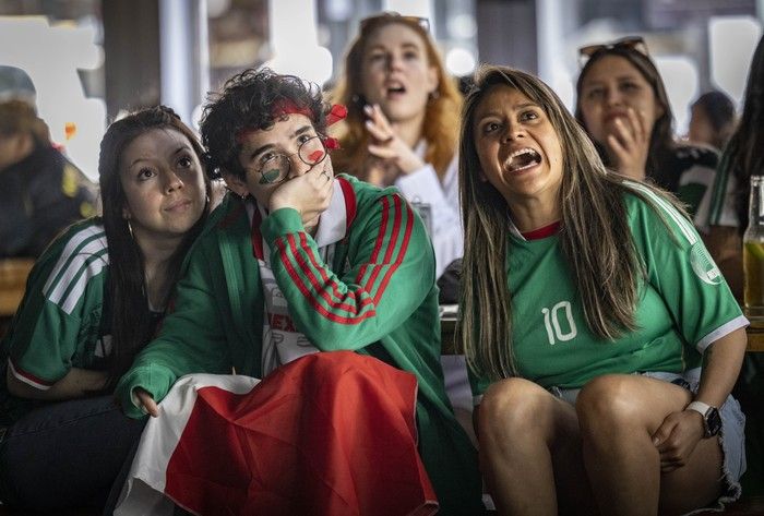 Mexican soccer fans (from left foreground) Dilara Karaca, Rodrigo Zertuche and Nadia Sanchez watch the opening match of the FIFA World Cup 2026 at The Cambie in Vancouver on June 11, 2026. Fans could watch the opening match from several areas Thursday, including the FIFA Pedestrian Zone on Granville Street in downtown Vancouver.