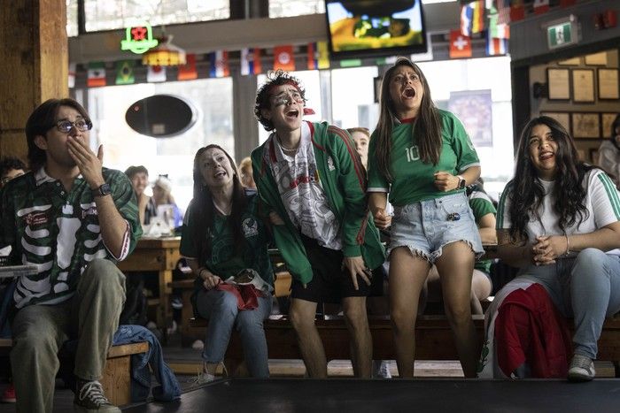 Mexican soccer fans (from second left foreground) Dilara Karaca, Rodrigo Zertuche, Nadia Sanchez and Kenia Lopez watch the opening match of the FIFA World Cup 2026 at The Cambie in Vancouver on June 11, 2026. Fans could watch the opening match from several areas Thursday, including the FIFA Pedestrian Zone on Granville Street in downtown Vancouver.