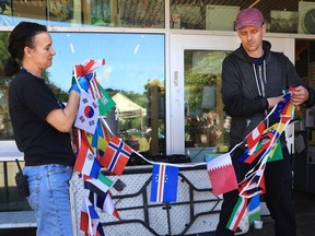 A string of international flags is hung up as part of the World Cup preparations at Vancouver's Oppenheimer Park.