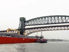 The tugboat HaiSea Wamis escorts an oil tanker in the Second Narrows, spanned by two key bridges, a railway bridge (foreground) and the Ironworkers Memorial highway bridge (background