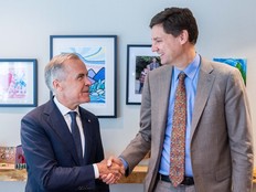 Premier David Eby and Prime Minister Mark Carney shake hands after announcing a multi-billion-dollar agreement to develop resources and infrastructure in the province.