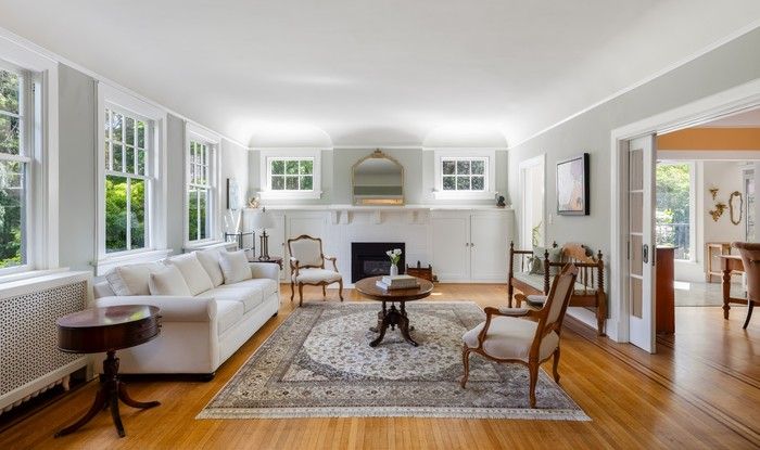 Home showcases rich hardwood floors with inlay detailing and decorative crown molding.
