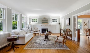 Home showcases rich hardwood floors with inlay detailing and decorative crown molding.