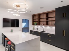 The use of lower drawers allows stored items to be viewed and accessed more easily than items placed in deep base cabinets, says Studio Ten Interior Design's Lori Sutherland Burns. Contrasting cabinetry, countertops and hardware make surfaces and handles easier to distinguish, while under-cabinet lighting improves visibility for daily tasks. The large central work surface also supports shared tasks and accommodates seated participation when required.