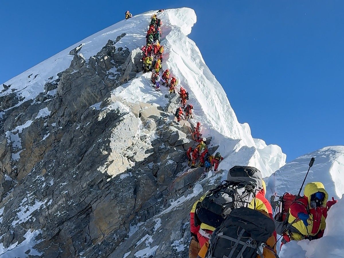  (FILES) This photograph taken on May 20, 2026, shows mountaineers climbing a slope lined up during their ascent from the Hillary Step to summit Mount Everest in Nepal.