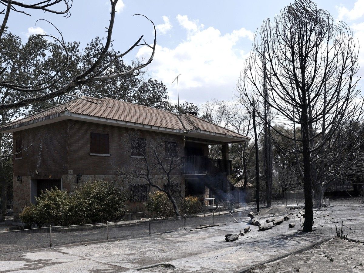  A picture taken on July 25, 2026 shows a house in a burnt landscape between Colmenar del Arroyo y Robledo de Chavela, 50 km west of Madrid, as wildfires have burned up to 25,000 hectares.