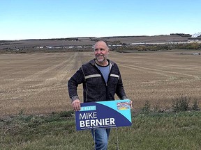 Mike Bernier stands with an election sign