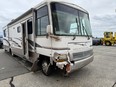 A motorhome with some damage to the front of the vehicle.