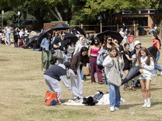 People line up near Kits pool for a Rhode Pop Up booth on July 9, 2026.