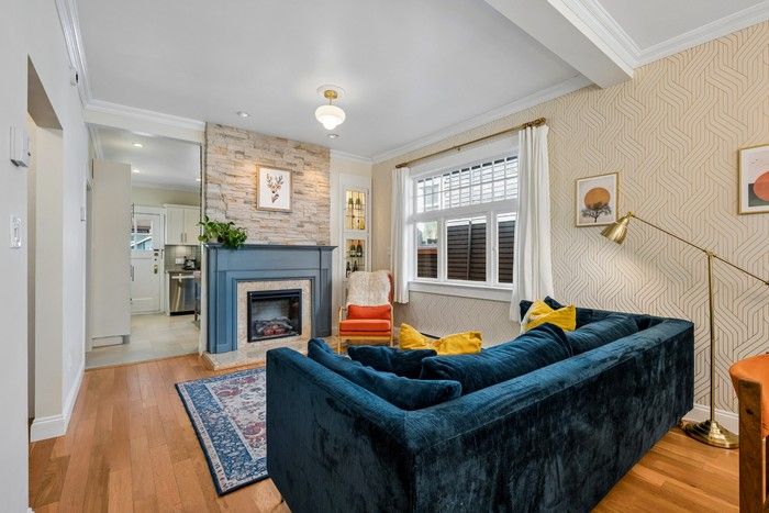 Living room with an electric fireplace and linear stone tiles above the mantelpiece.