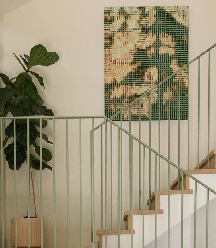 'Sun Glitter,' a 48 by 36-inch pixelated-style acrylic on canvas by Vancouver-based graphic designer-turned-artist Steve Fortier, is a conversation piece in the staircase.