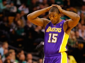 Metta World Peace #15 of the Los Angeles Lakers folds his hands over his head during the game on February 7, 2013 at TD Garden in Boston.