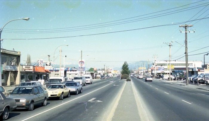  March 3 1989, Businesses along King George Hwy and 104 Ave including Surrey Foam and Fabrics, Design Upholstery, the Round-Up Cafe, Super Save Gas, the Rickshaw restaurant, and the Dell Hotel. City of Surrey Archives