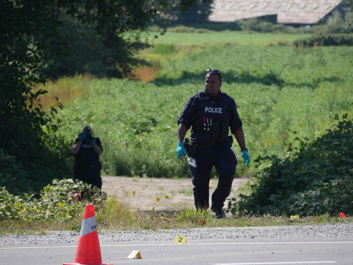 Delta Police, in the 6400-block of River Road, investigate after a woman's body was discovered around 6:10 a.m. Wednesday after a fire in a field.