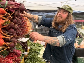Farmers sell beets and greens at a farmers market in Vancouver.
