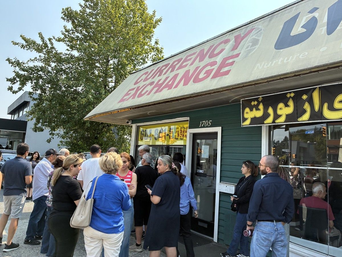 Customers of Apadana Currency Exchange in North Vancouver seek answers on Aug. 17, 2026 after being informed that their transactions were being frozen due to the business's financial troubles.