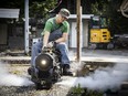 Volunteer engineer Jayden with a steam locomotive.