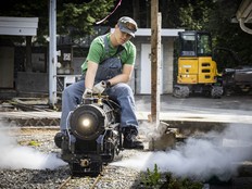 Volunteer engineer Jayden with a steam locomotive.