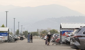 People walk back to their cars after shopping in Penticton on Aug. 10, 2026.
