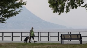 People stroll near Okanagan Lake Beach in Penticton on Aug. 10, 2026.