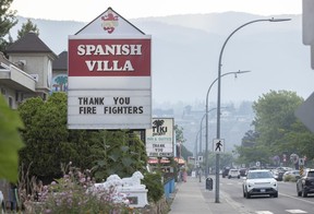 People stroll and play near Okanagan Lake Beach in Penticton on Aug. 10, 2026.