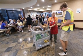 Volunteers help people affected by the Summerland fires at the Penticton Trade and Convention Centre on Aug. 10, 2026.