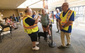 Volunteers help people affected by the Summerland fires wait at the Penticton Trade and Convention Centre on Aug. 10, 2026.