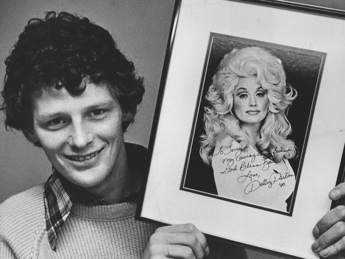 Undated photo of Terry Fox with picture of Dolly Parton.