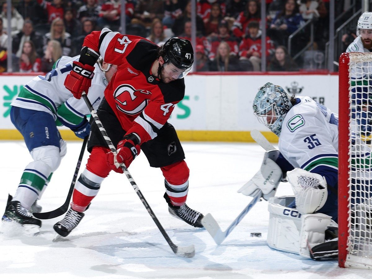 Paul Cotter tries to get a shot past Thatcher Demko in a game at Prudential Center on March 24, 2025 in Newark, New Jersey