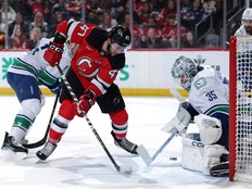 Paul Cotter tries to get a shot past Thatcher Demko in a game at Prudential Center on March 24, 2025 in Newark, New Jersey