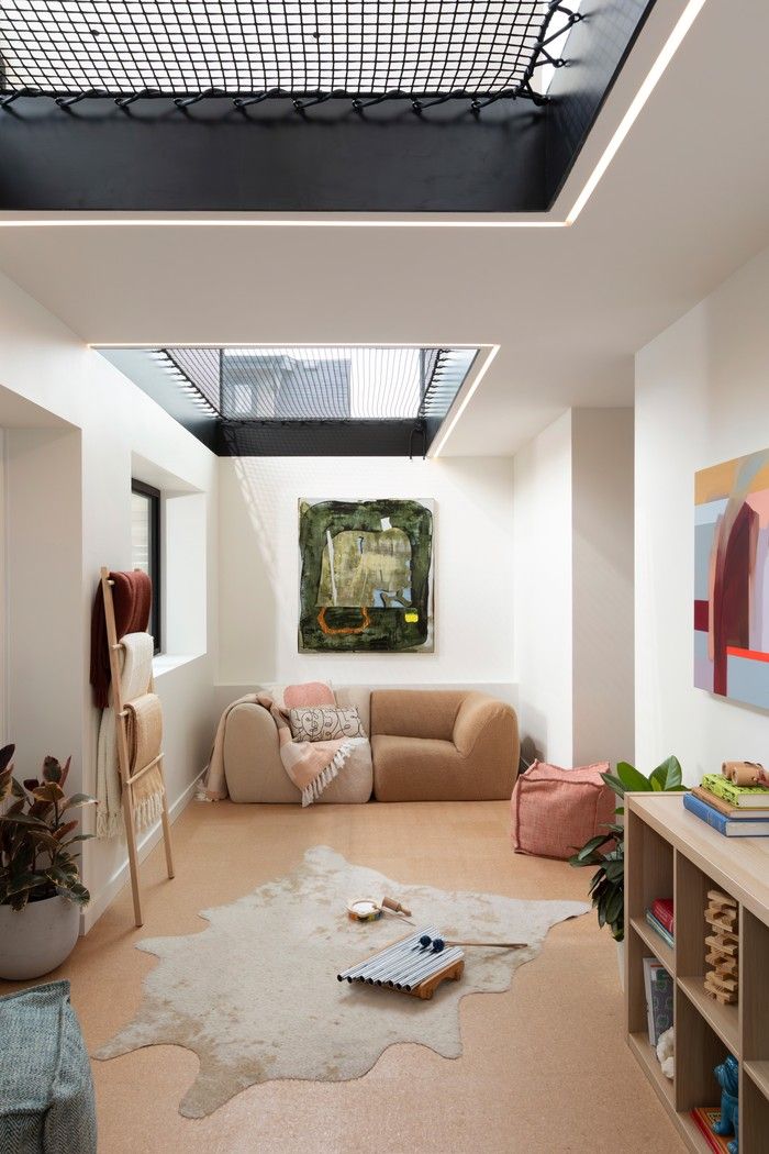 Two hammock-like mesh openings create extra spaces to lounge and play, while allowing daylight from the rear windows to reach the lower level of the home. After dark, under-mounted LED strips cast a soft underglow. Two hammock-like mesh openings create extra spaces to lounge and play, while allowing daylight from the rear windows to reach the lower level of the home. After dark, under-mounted LED strips cast a soft underglow.