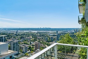Condo has two balconies with glass-panel railings.