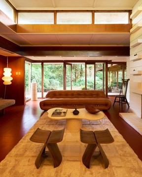 The living room of the Mahogany House in North Vancouver featureds floor to ceiling windows. The house was designed by west coast modern architect Fred Hollingsworth in 1952.
