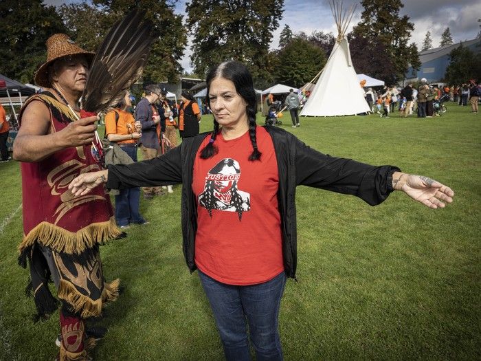 Travis Angus from the Niagara Nation performs a cleansing ceremony for Catherine Chapman during National Day for Truth and Reconciliation event at Queen's Park in New Westminster on Wednesday, September 30.