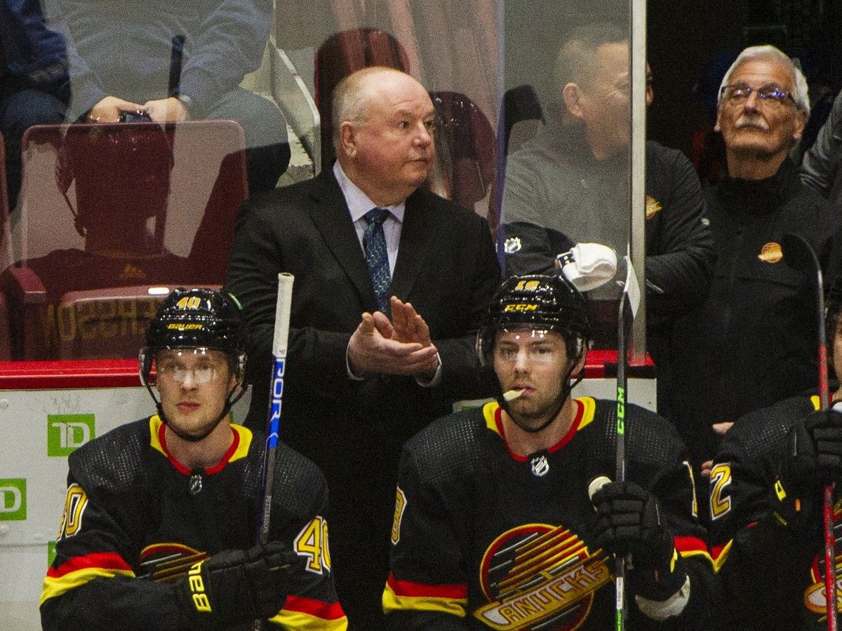 Canucks head coach Bruce Boudreau applauds announcement of Quinn Hughes overtaking Doug Lidster as the all-time points leader for Canucks defencemen in April 2022.