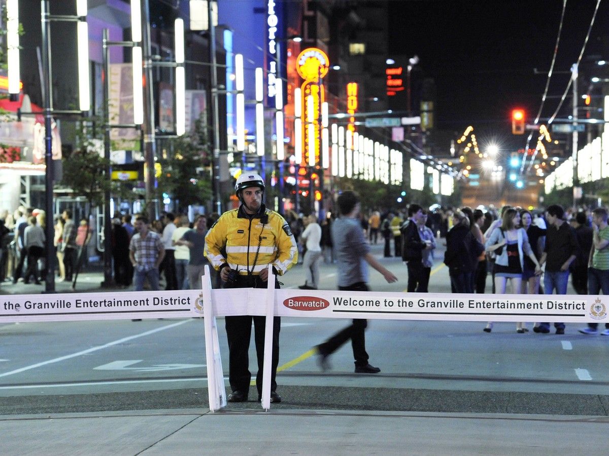 File photo: A traffic authority officers stands by the traffic barriers closing Granville Street in the entertainment district in July 2011.