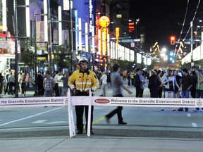 File photo: A traffic authority officers stands by the traffic barriers closing Granville Street in the entertainment district in July 2011.