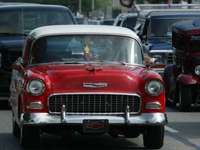 A 1955 Chevy rolls down Woodward Avenue in Detroit at the Dream Cruise, the largest car show in the world.