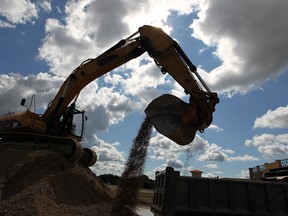 Workers on Highway 3 near the Outlet Mall move crushed stone for the Windsor Essex Parkway project August 10, 2011.