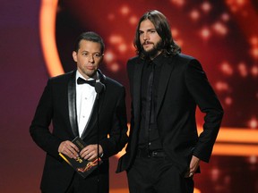 Actors Jon Cryer (L) and Ashton Kutcher speak onstage during the 63rd Annual Primetime Emmy Awards held at Nokia Theatre L.A. LIVE on September 18, 2011 in Los Angeles, California. (Kevin Winter/Getty Images)
