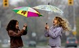 Cousins Valentina DiPietro, 8, left, and Zelia Piasentin, 8,  are all smiles as they make their way down Curry Avenue in south Windsor during  a steady rainfall on April 25, 2011 in Windsor, Ont.  (Jason Kryk/The Windsor Star)