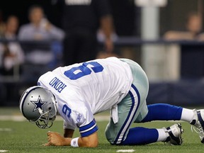 Tony Romo #9 of the Dallas Cowboys gets up after being hit during their game against the Washington Redskins at Cowboys Stadium on September 26, 2011 in Arlington, Texas.  (Photo by Tom Pennington/Getty Images)
