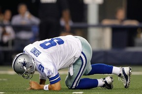 Tony Romo #9 of the Dallas Cowboys gets up after being hit during their game against the Washington Redskins at Cowboys Stadium on September 26, 2011 in Arlington, Texas.  (Photo by Tom Pennington/Getty Images)