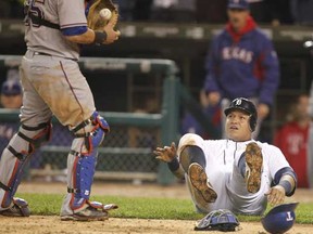 The Detroit Tigers' Miguel Cabrera, right, is retired by Texas Rangers catcher Mike Napoli as he tries to score from third in the eighth inning off of a sacrifice fly hit by Delmon Young in Game 4 of the American League Championship Series at Comerica Park in Detroit, Michigan, Wednesday, October 12, 2011. Texas won in 11 innings, 7-3. (Julian H. Gonzalez/Detroit Free Press/MCT)